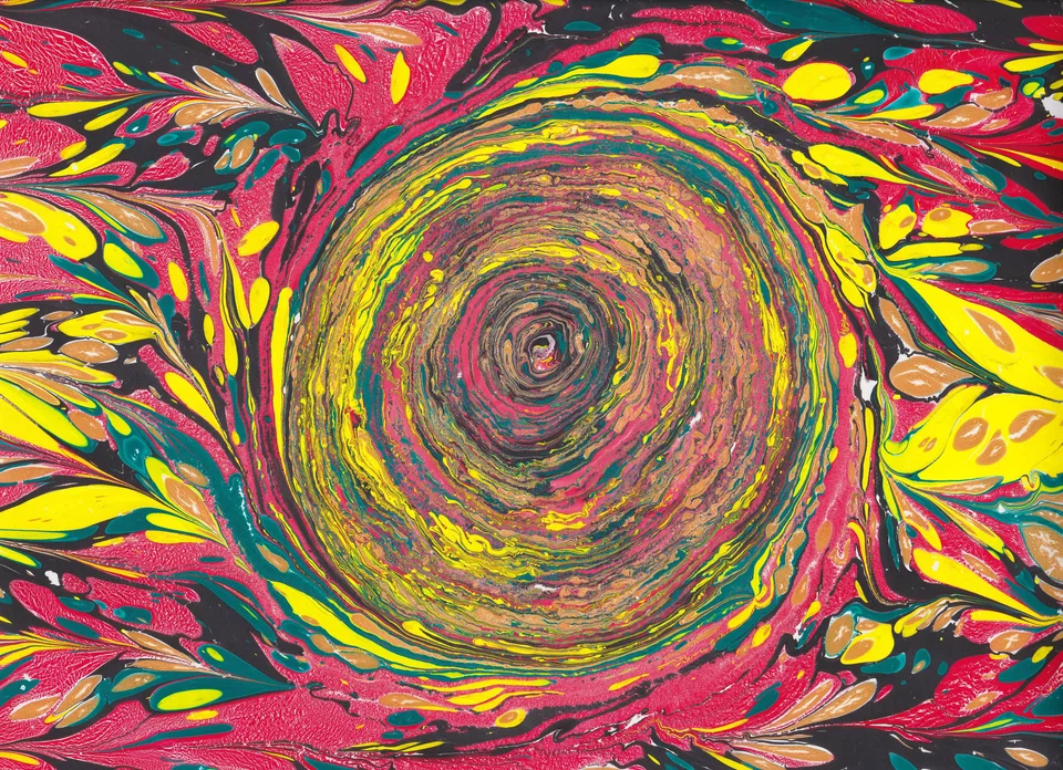 A marbled composition with a dense circular swirl and yellow and pink patterns
