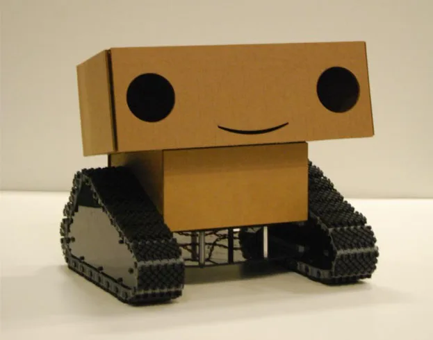 Boxie, a smiling cardboard robot with tank treads