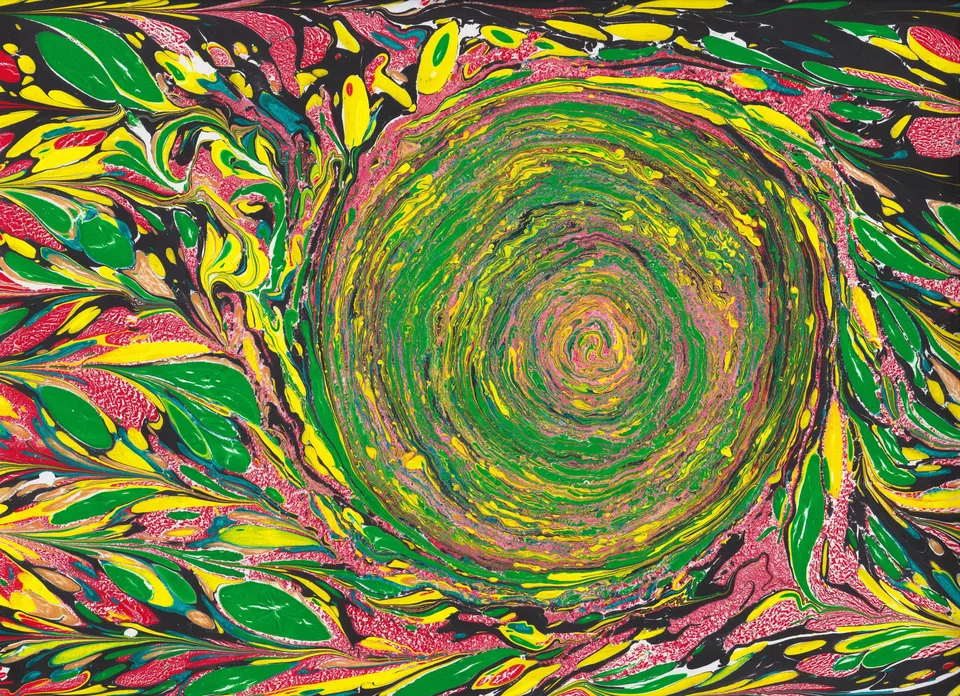 A circular green and yellow marbled form surrounded by pink and black patterns