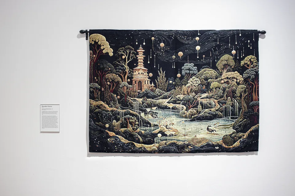 A dark tapestry shows a pagoda above wooded slopes, pale streams and small creatures, with round lights suspended across the sky.