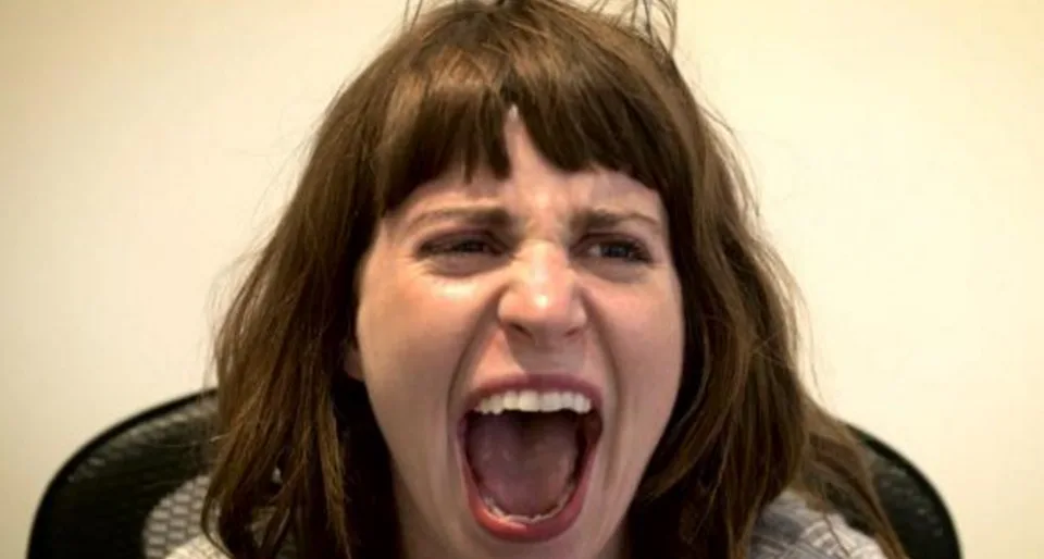 A participant reacting to the Headgasmatron head scratcher